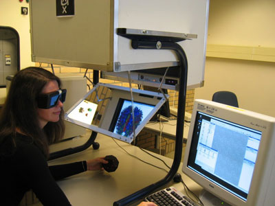 Figure 1: The Personal Space Station (PSS) offers stereoscopic visualization and direct interaction by means of tracked objects. Picture: UvA.